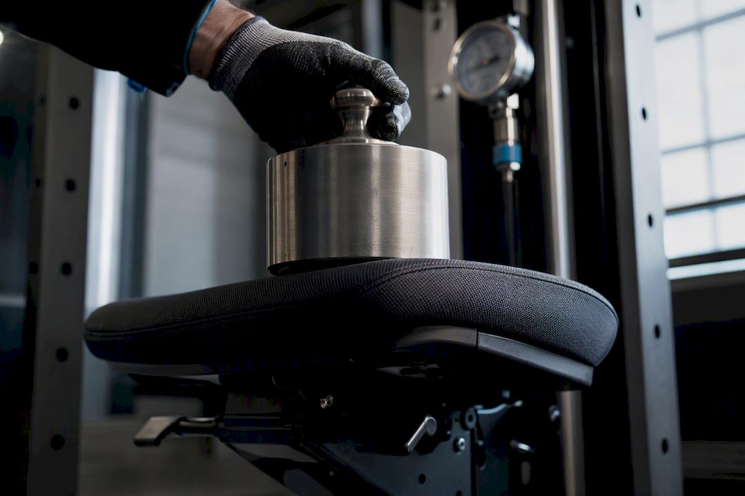 Technician loading an anonymous chair test fixture