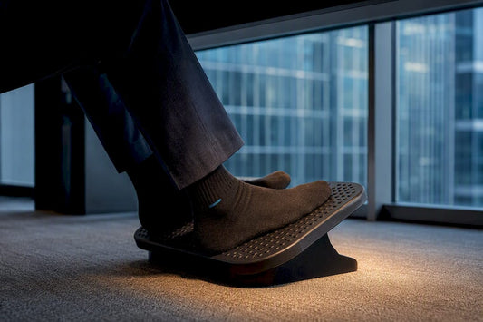 Feet repositioning on an under-desk foot platform